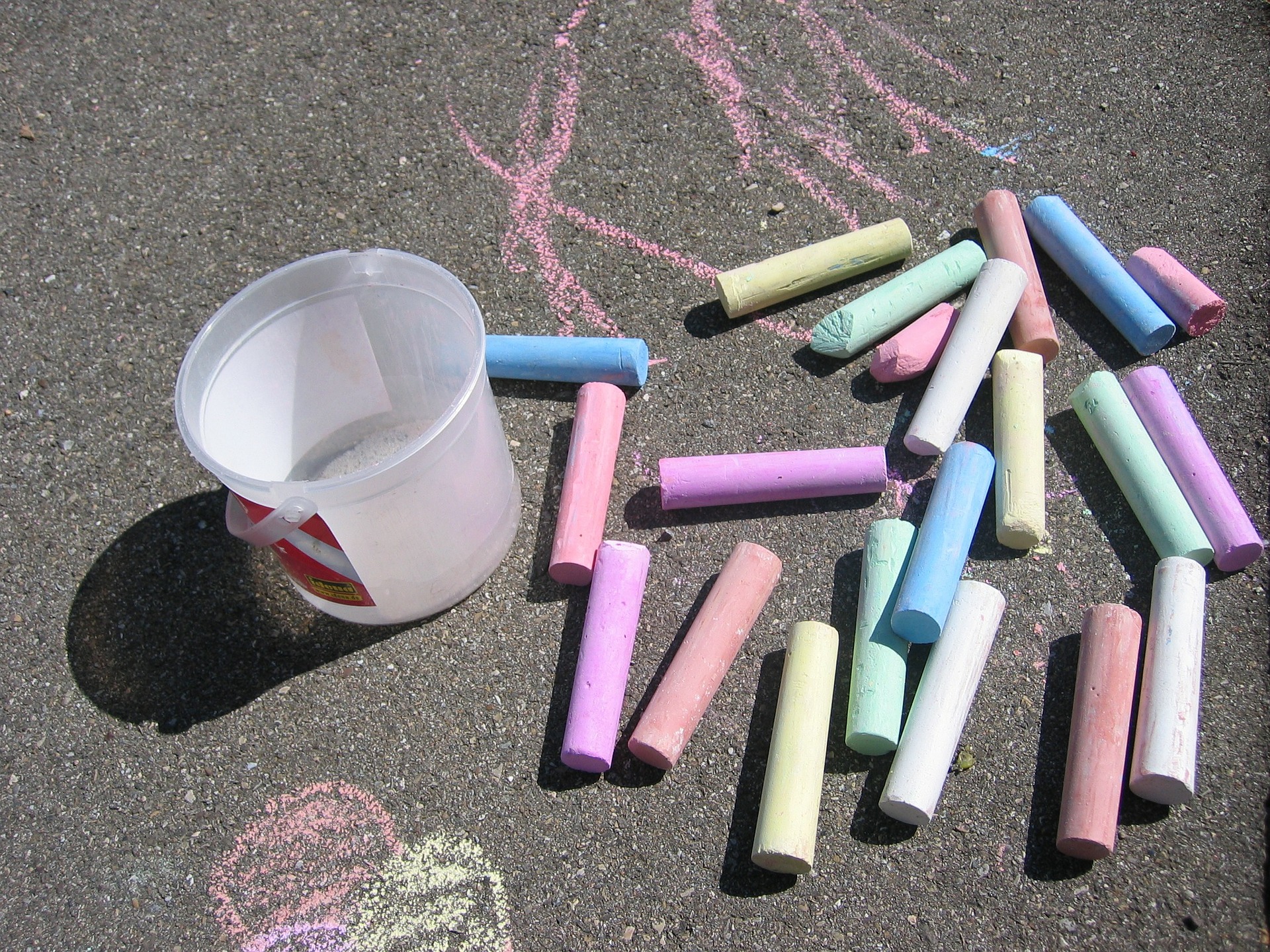 sidewalk chalk on a road, with a drawing of some lines and a heart